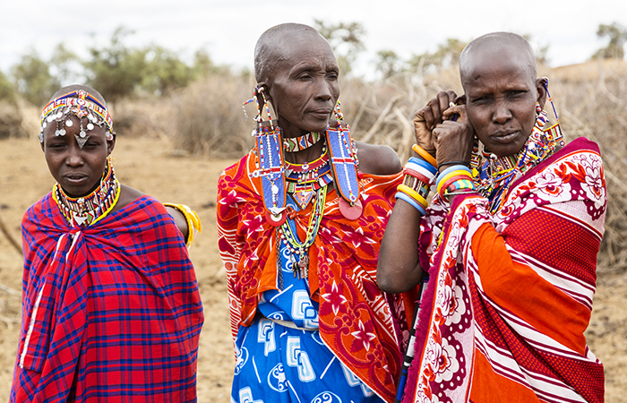 Three Maasai women in their traditional garb in Kenya